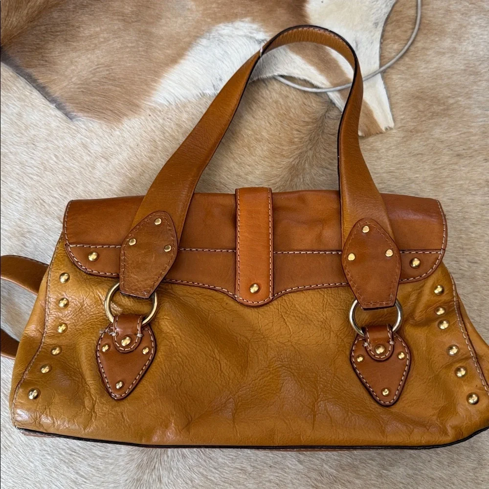 This is a vintage Michael Kors brown leather shoulder bag featuring gold studs
